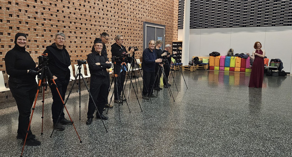 Men in black, woman in red